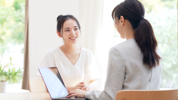 two woman talking across the table 