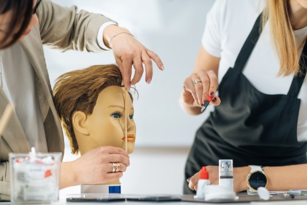 cosmetology students studying face structure